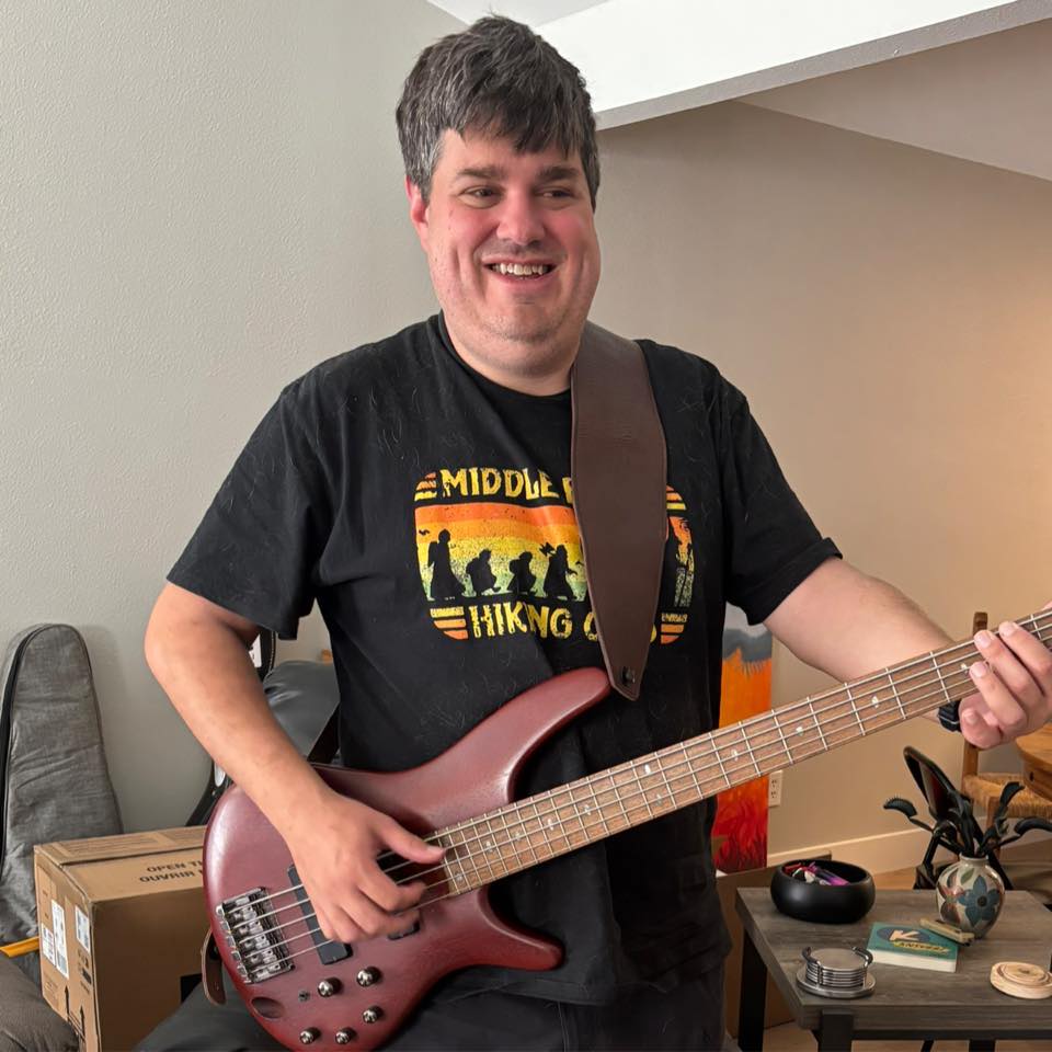 Seth Wilson holding a bass guitar